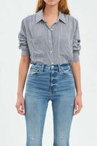 Navy and white striped button-up top with a collar, white buttons, two chest pockets, and rolled sleeves.