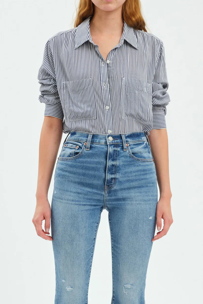 Navy and white striped button-up top with a collar, white buttons, two chest pockets, and rolled sleeves.