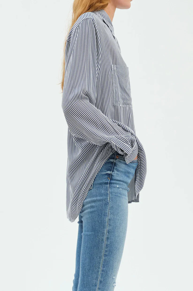 White and navy striped button-up top with rolled sleeves, chest pocket, and a high-low hem.