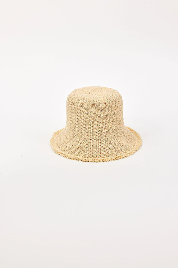 Light beige woven bucket hat with a round crown and a soft, frayed brim.