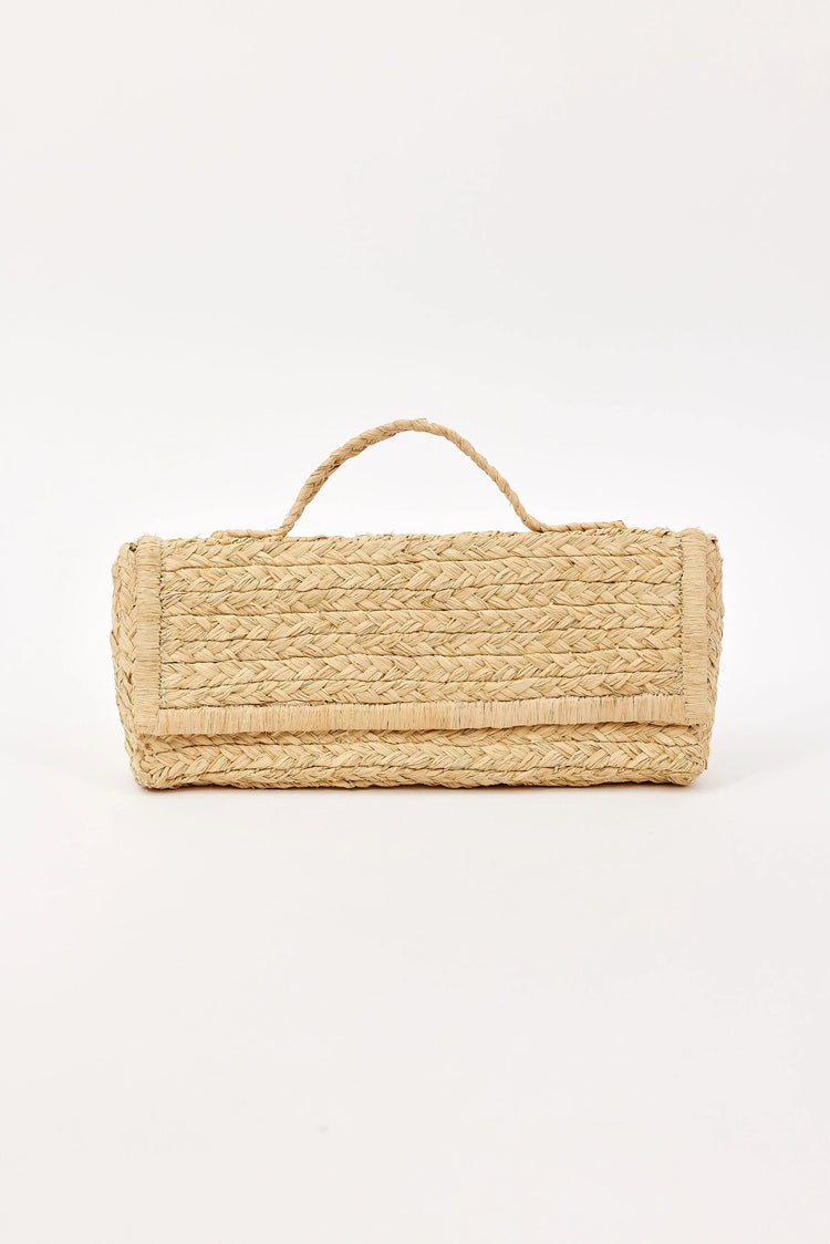 Natural tan woven straw clutch with a short top handle and front flap.