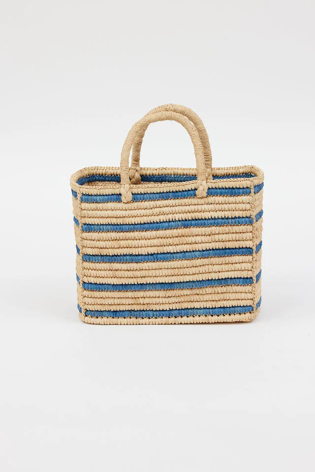 Natural beige woven straw tote bag with blue horizontal stripes and two top handles.