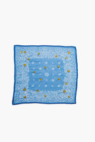 Light blue bandana with white paisley print border, scattered gold embroidered flowers, and a dark blue edge.