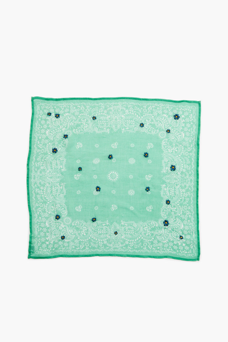 Square mint green bandana with white paisley print and scattered small blue and yellow embroidered flowers.