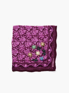 Dark purple bandana with magenta floral lattice print. Features an embroidered border and yellow, green, blue accent flowers.