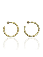 A pair of gold hammered hoop earrings with embedded clear stones and post backs.