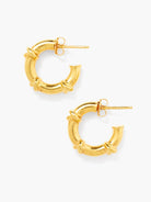 A pair of small gold C-hoop earrings with a wrapped design. Post backs are visible.