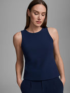 Deep navy knit scuba tank top featuring a high round neck and wide sleeveless shoulders.
