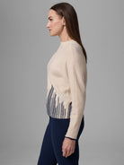 Cream sweater with navy blue flame stitch pattern on lower front. Navy trim on cuffs and hem.