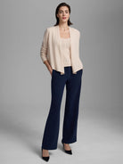Light cream cashmere tank with square neckline, worn under an open cardigan.
