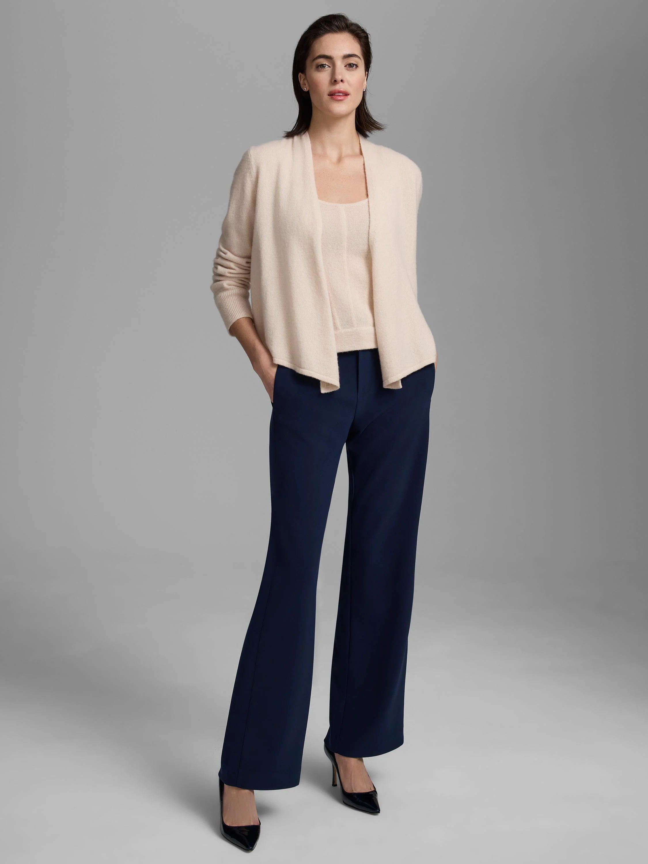 Light cream cashmere tank with square neckline, worn under an open cardigan.