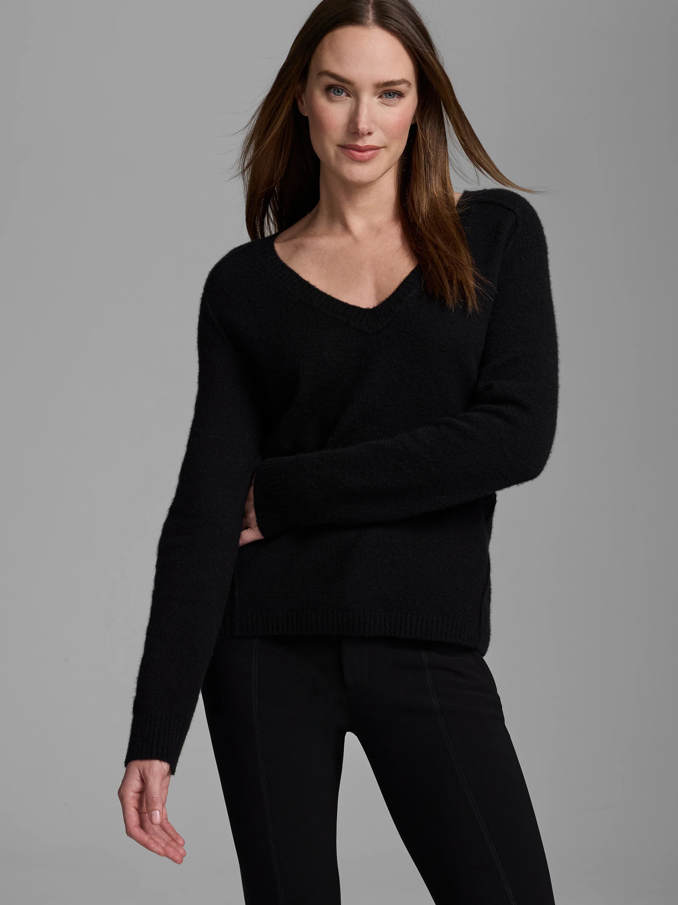 Black V-neck sweater with a soft, fuzzy texture, long sleeves, and ribbed cuffs and hem.