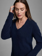 Navy V-neck sweater with a soft, fuzzy texture.