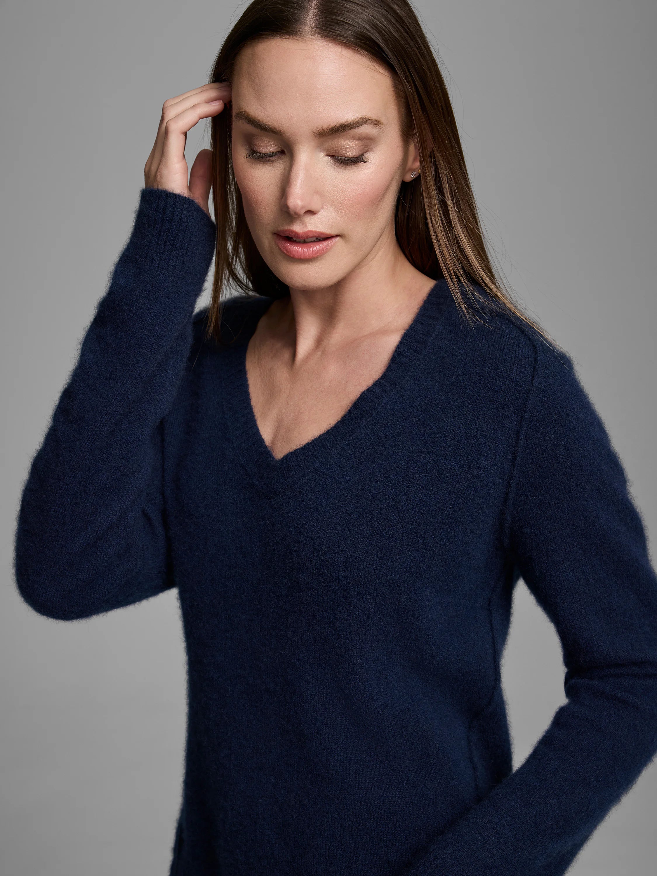 Navy V-neck sweater with a soft, fuzzy texture.