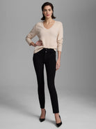 Light beige, fine knit V-neck sweater with long sleeves, ribbed cuffs, and a ribbed hem.