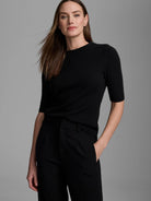 Black cashmere mock neck sweater with elbow-length sleeves and a soft, slightly fuzzy texture.