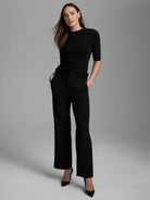 Black cashmere mock neck sweater with short sleeves and a soft, fuzzy texture.