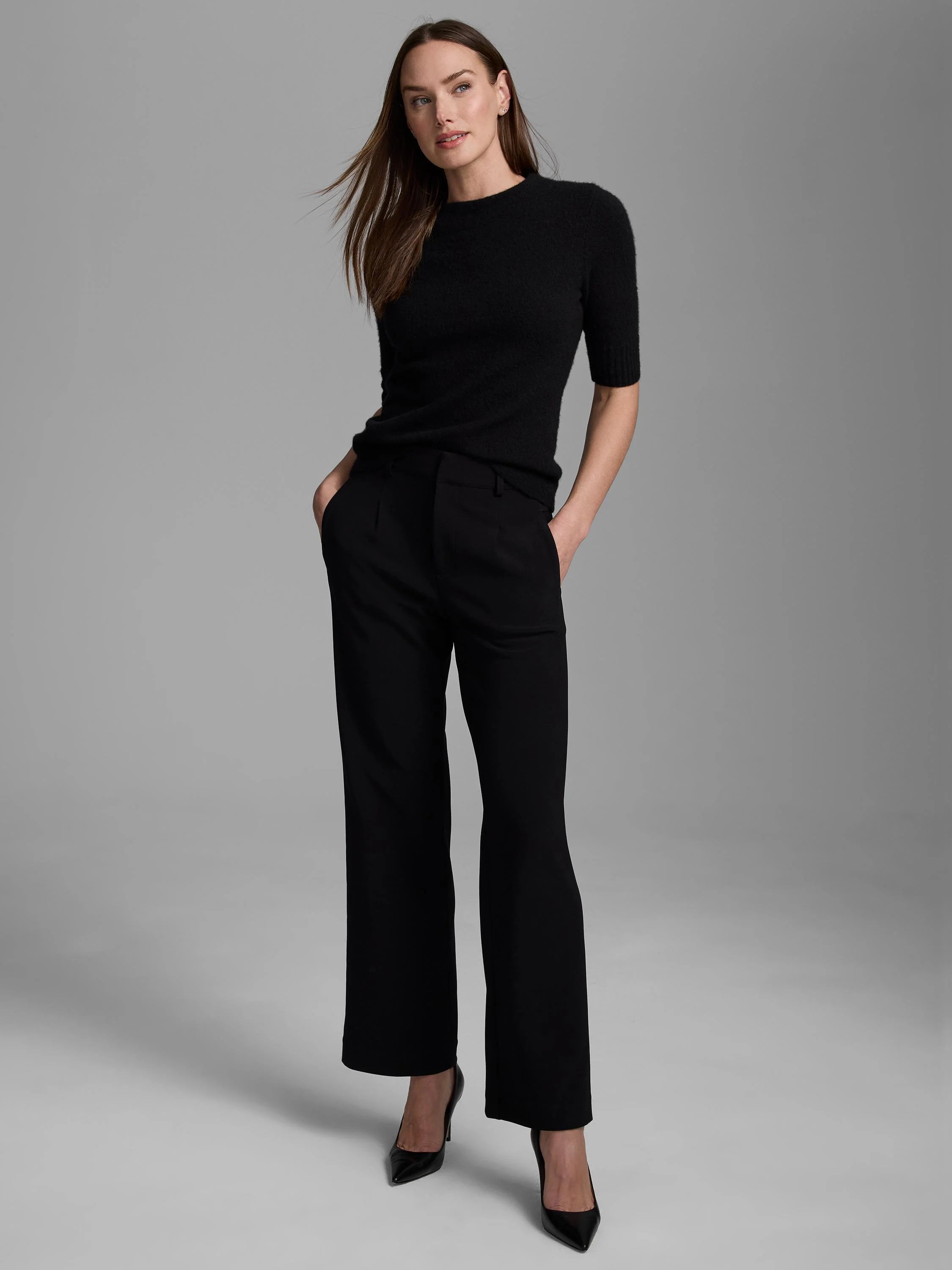 Black cashmere mock neck sweater with short sleeves and a soft, fuzzy texture.