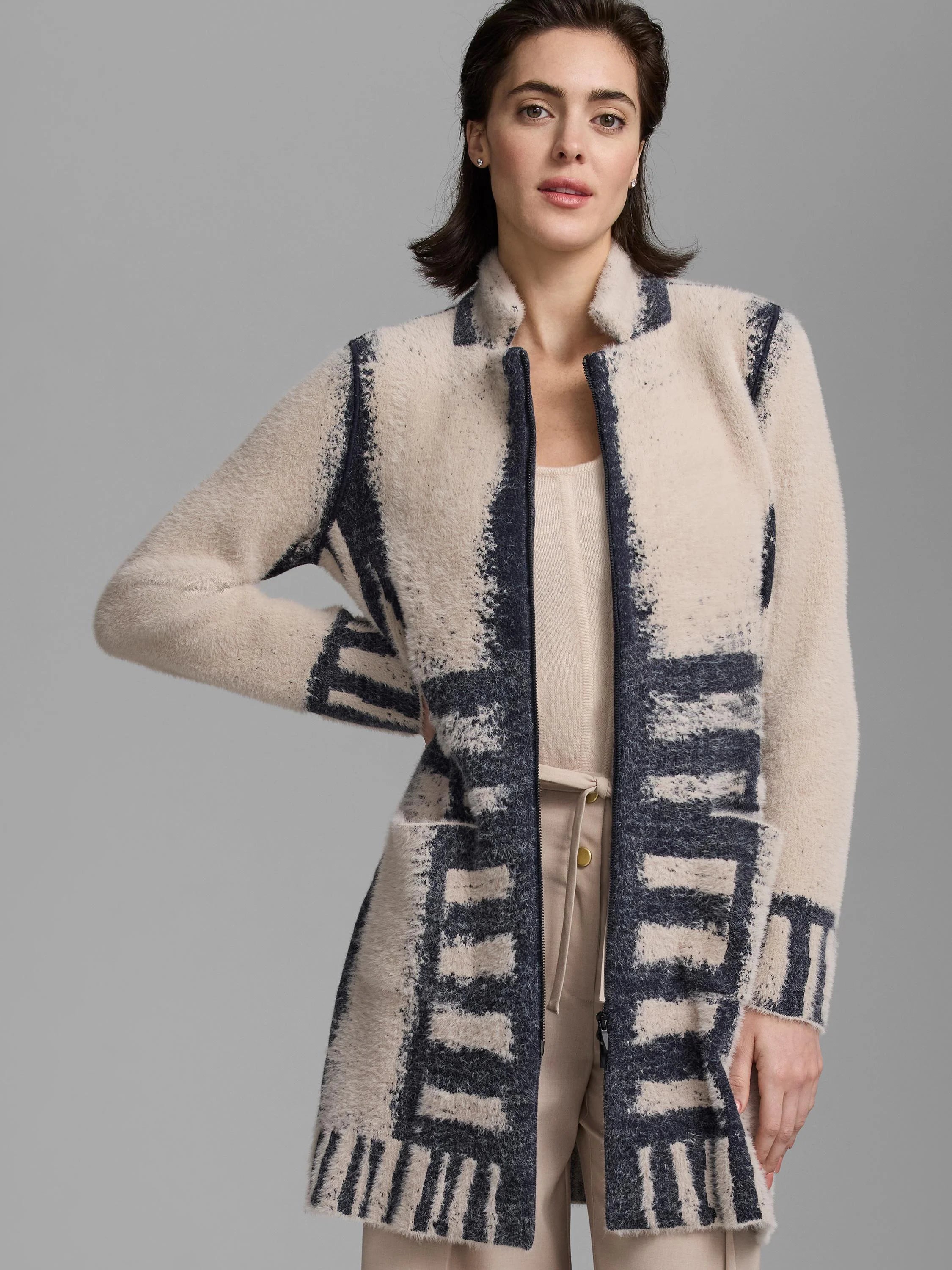 Fuzzy cream and navy jacket with abstract block patterns. Long, open front.