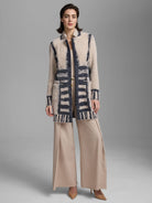 Oatmeal textured double-knit jacket with navy abstract bands and lines. Mid-thigh length, high collar, and pockets.