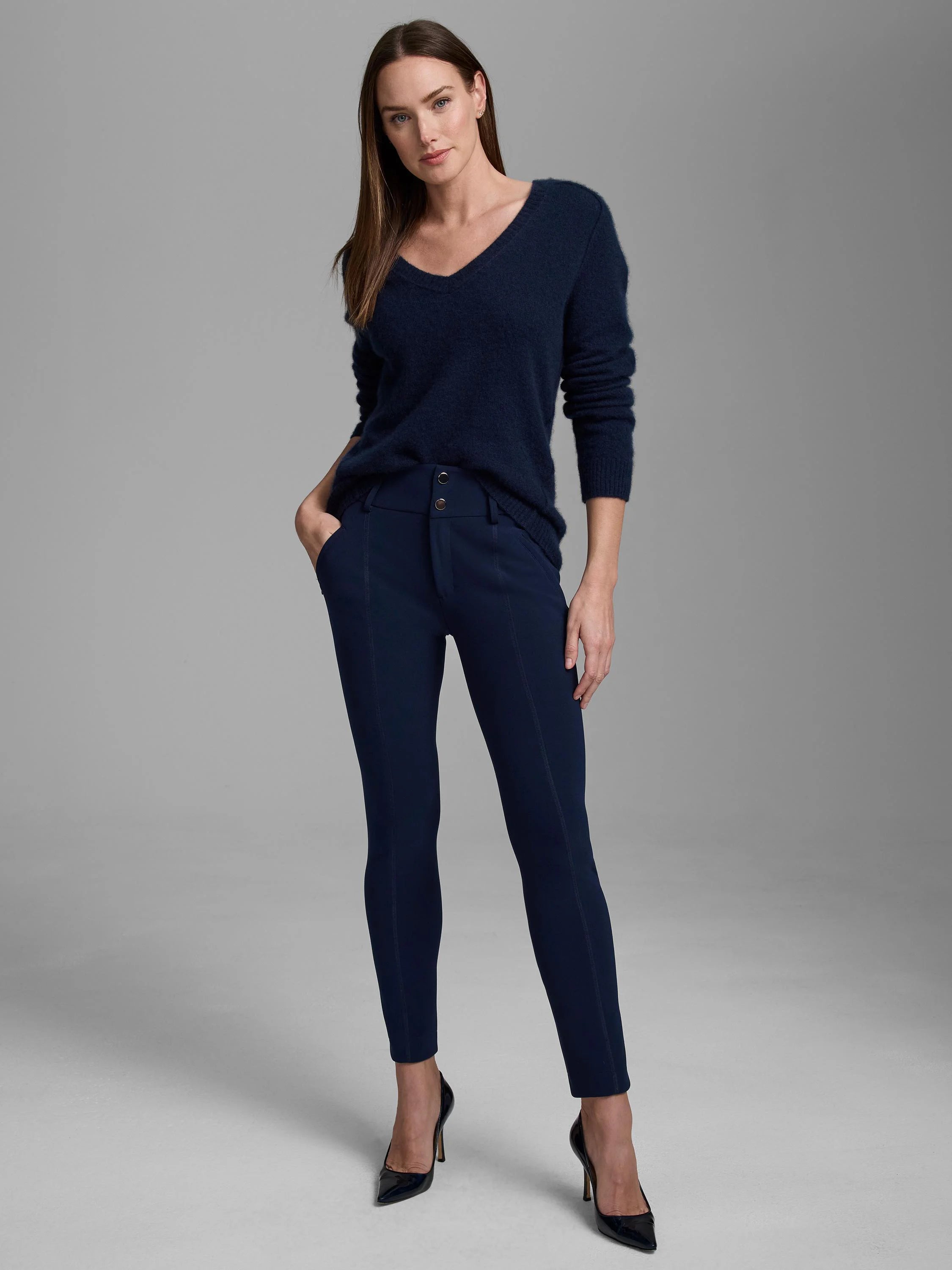 Navy slim-fit pants with two silver waist buttons and front seam details.
