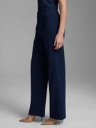 Navy blue wide-leg trousers. High-waisted with a front pleat and belt loops.