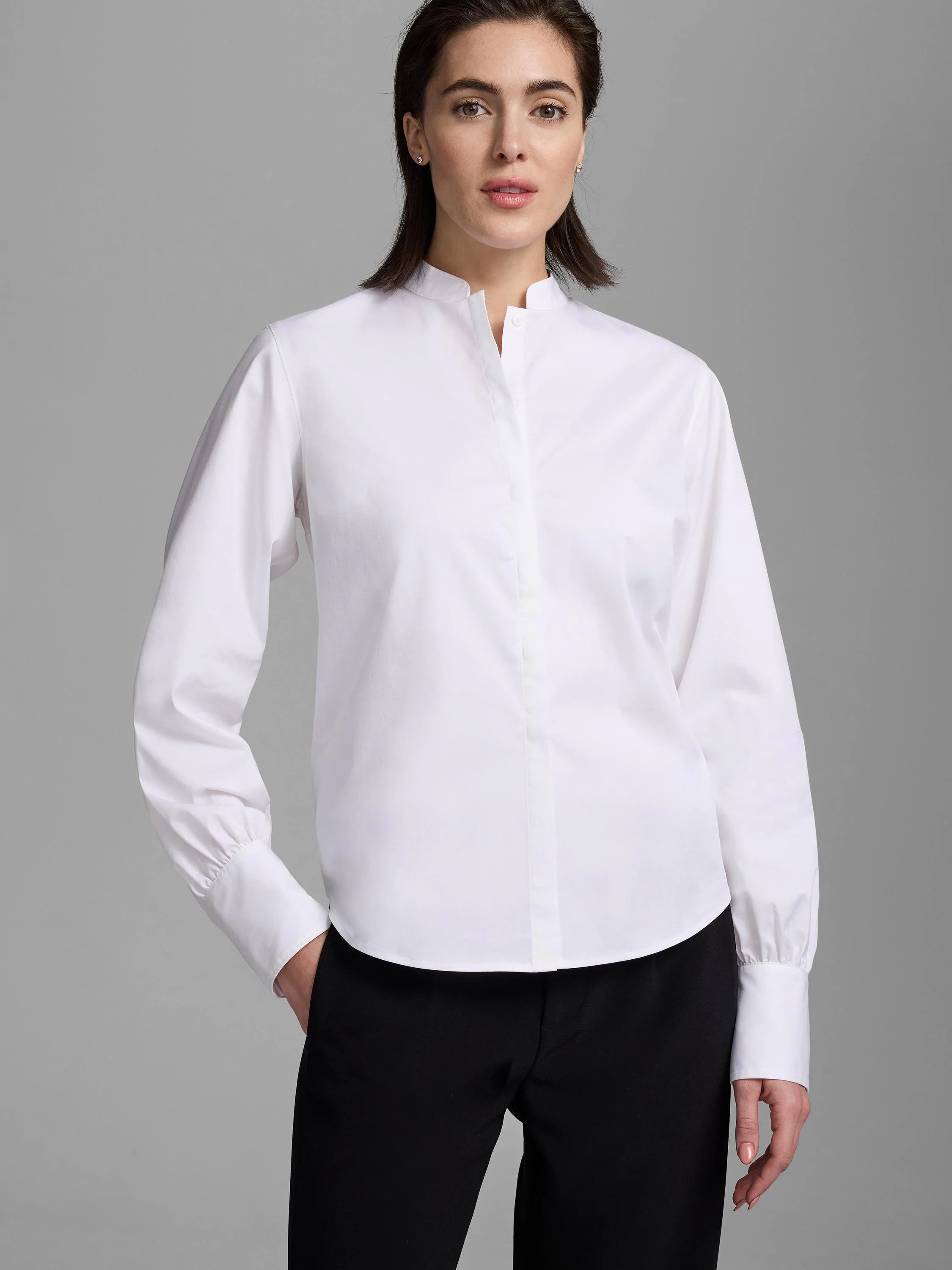 White stretch cotton shirt, band collar, hidden button placket, long sleeves with gathered cuffs.