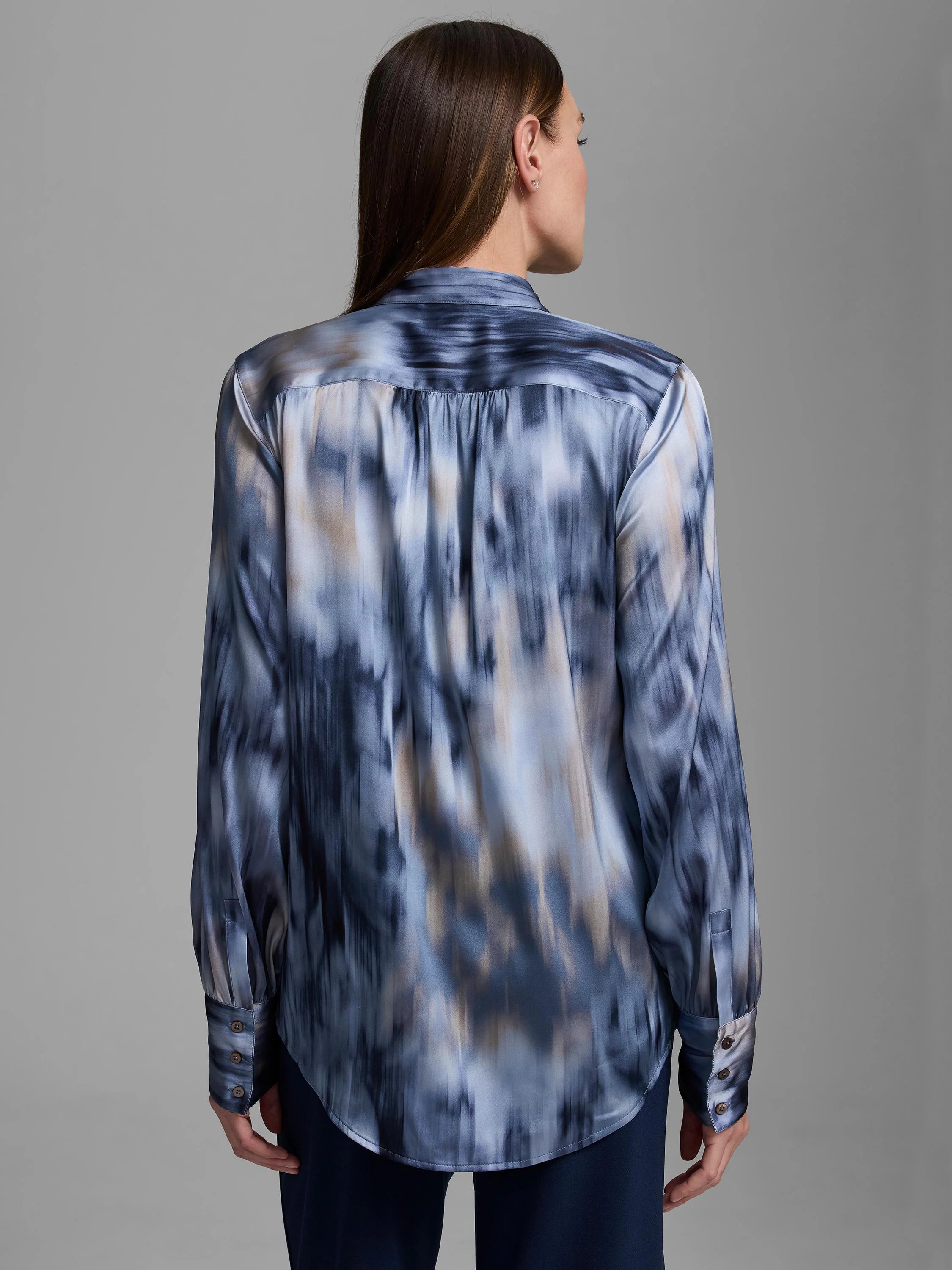 Blue and tan silk shirt with abstract vertical streaky pattern, long sleeves, buttoned cuffs, curved hem.