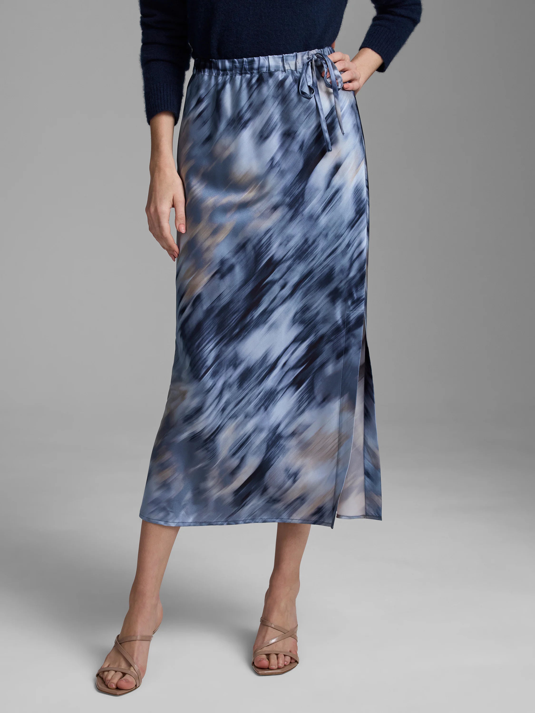 Silk midi slip skirt with an elastic tie waist, abstract blue, grey & beige print, and a left side slit.