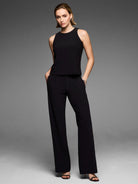 Black knit scuba tank with a high neck and sleeveless design.