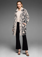 Textured cream coat with irregular black patterns, a fluffy cream collar, and a button-front closure.