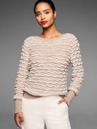 Light tan crewneck sweater with a raised, all-over cream-colored wavy stitch pattern.