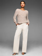 Beige sweater with a prominent, all-over raised cream-colored wave stitch pattern.