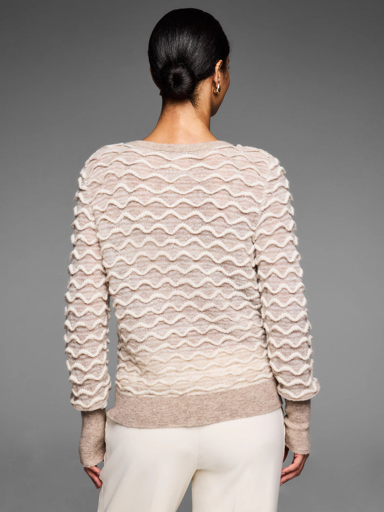 Oatmeal sweater with raised cream wavy stitch pattern, subtle ombre to light brown at hem & cuffs. Worn from back.