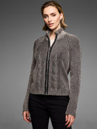 Black & beige knit zip cardigan with textured vertical stripes & chevron patterns. Features a ruffled stand collar &...