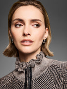 Black and beige engineered knit zip cardigan with a ruffled stand collar and black faux leather zipper trim.