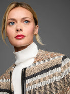 Woven knit jacket with varied textures in tan, black, white, & orange. Features a black zipper.