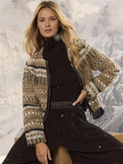 Short knit jacket with complex tan, black, and white woven geometric patterns. Features a black front zipper and fringe...