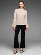 Pale beige pointelle knit sweater with fluffy faux fur cuffs.