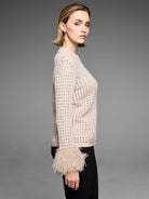 Light beige pointelle knit sweater with shaggy faux fur cuffs on a model.