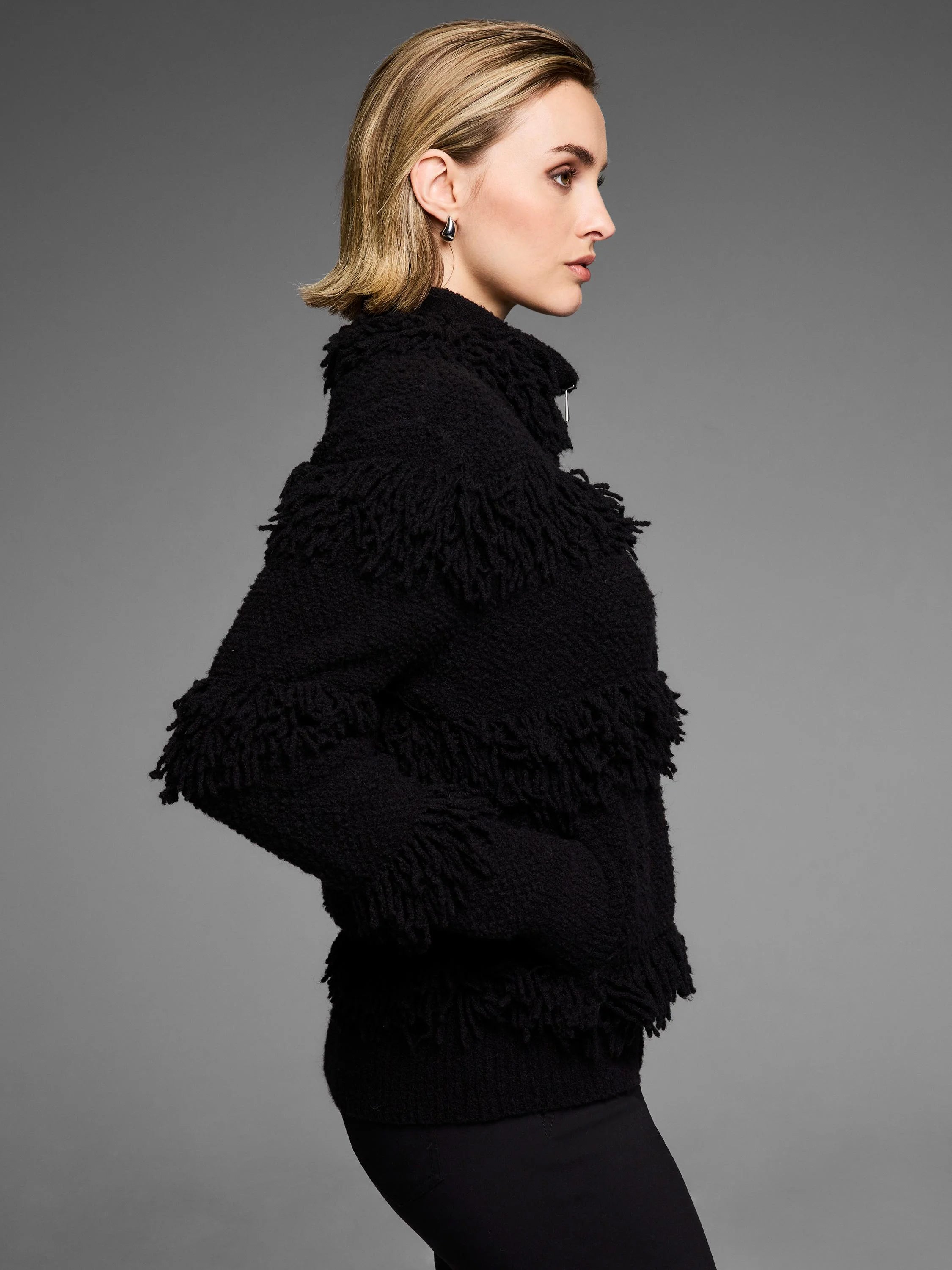 Black placed fringe jacket with high collar and front zipper.