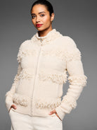 Off-white textured zip-up jacket with horizontal rows of shaggy fringe on the body and sleeves.