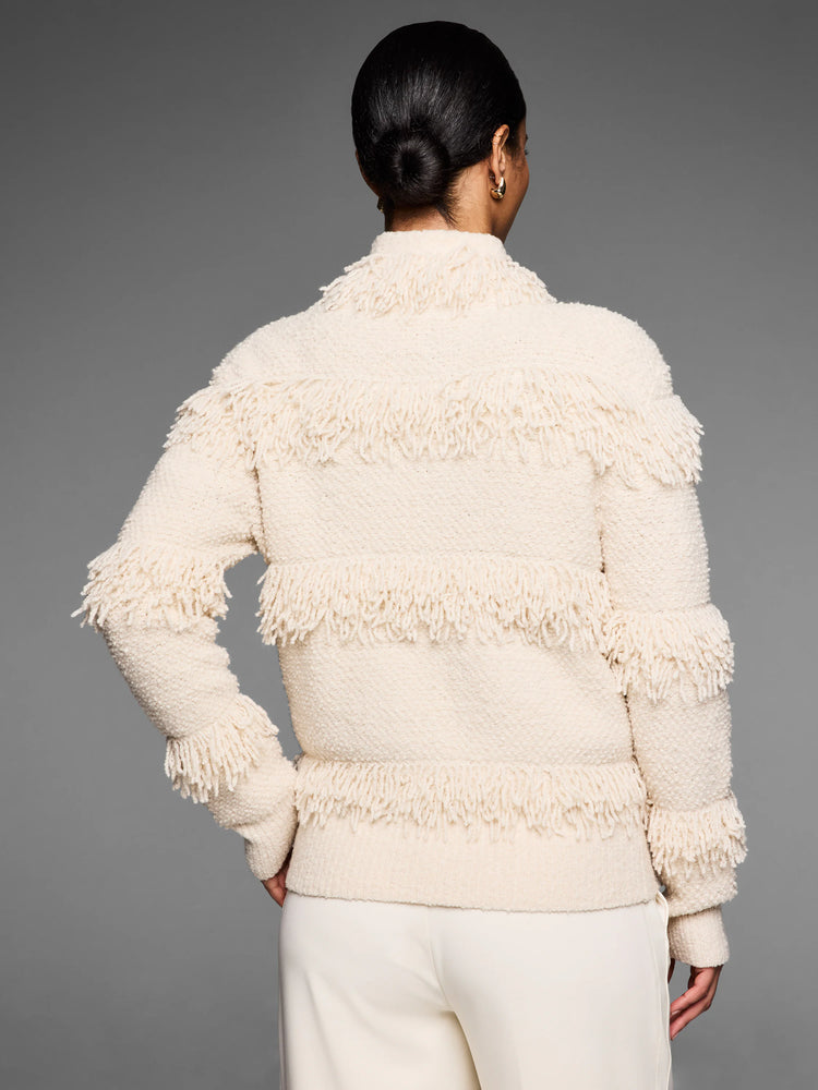 Cream knit jacket with horizontal shaggy fringe rows on the back, sleeves, and high collar.