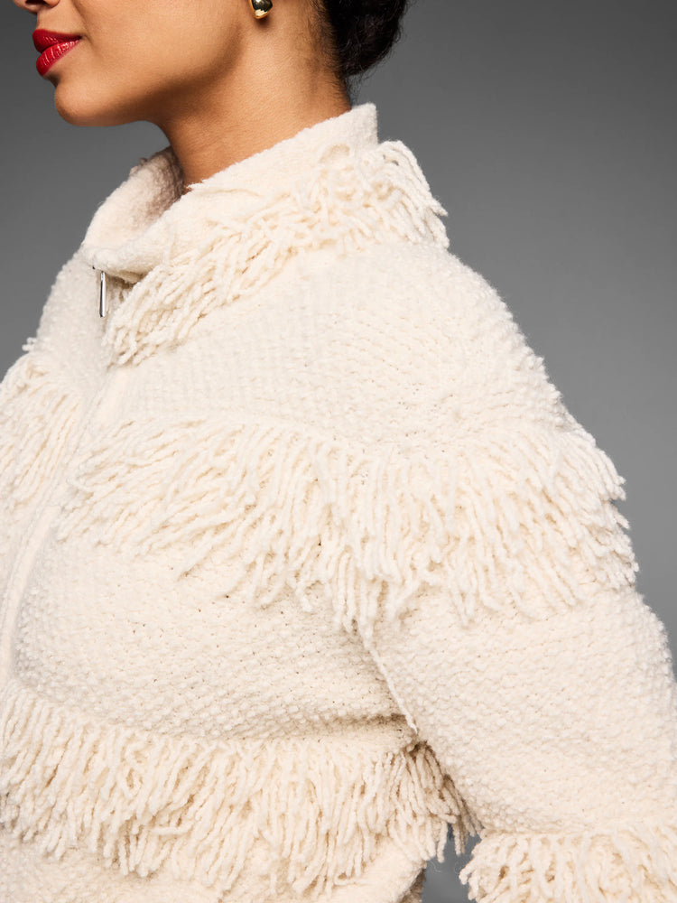 Ivory knit jacket with placed fringe layers across body and sleeves. Silver zipper.
