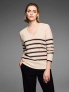 Light beige V-neck sweater with black and light brown horizontal stripes and subtle sparkle.