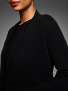 Black cashmere blend coat with a plain knit body, ribbed sleeves, and lapel collar.