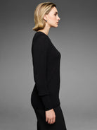 Black long-sleeved sweater with an all-over raised dot texture.
