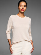 Light beige crew neck sweater with small raised dot texture.