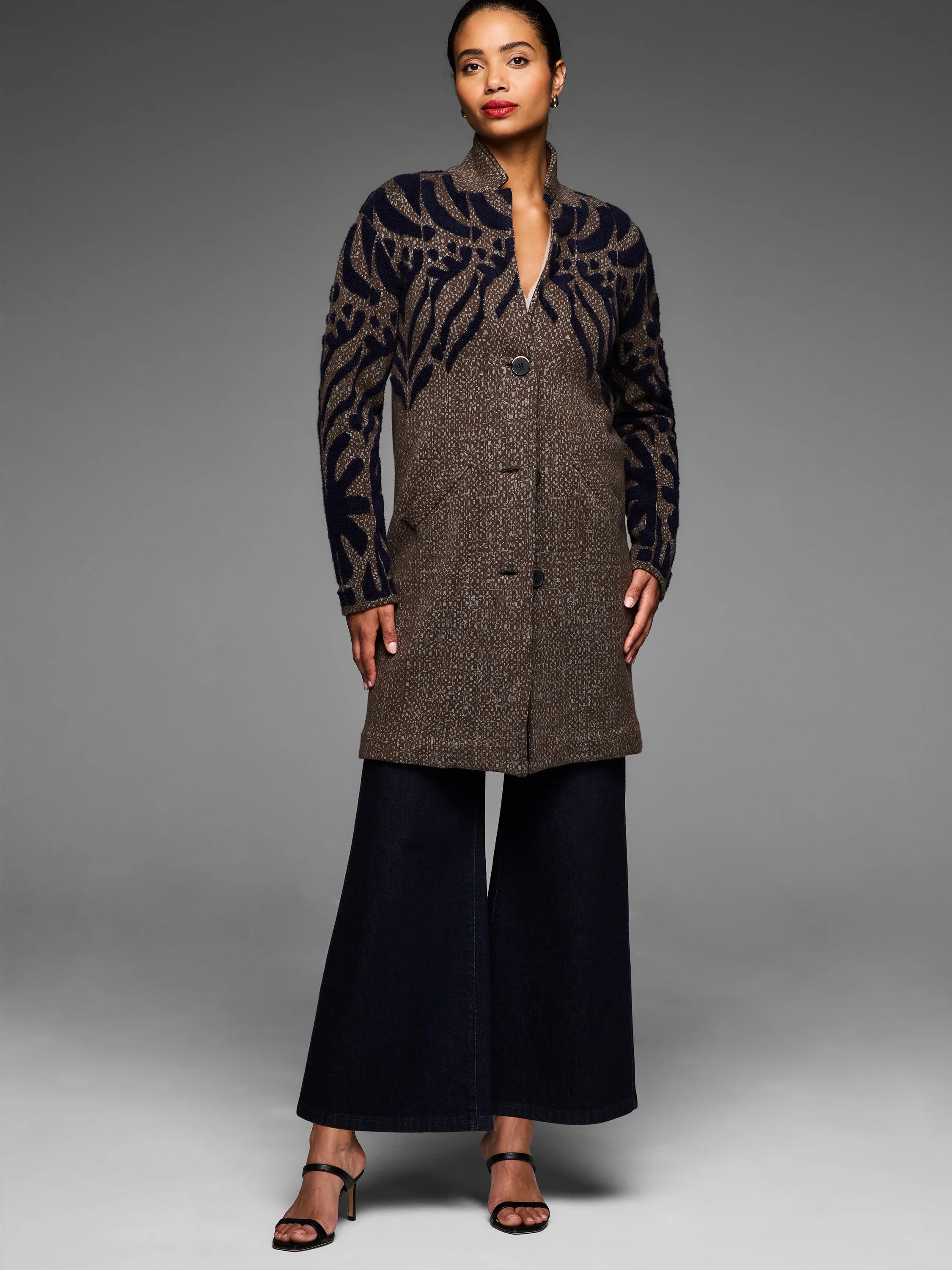Brown & navy tufted double knit coat, abstract pattern sleeves, stand collar, 3 buttons.