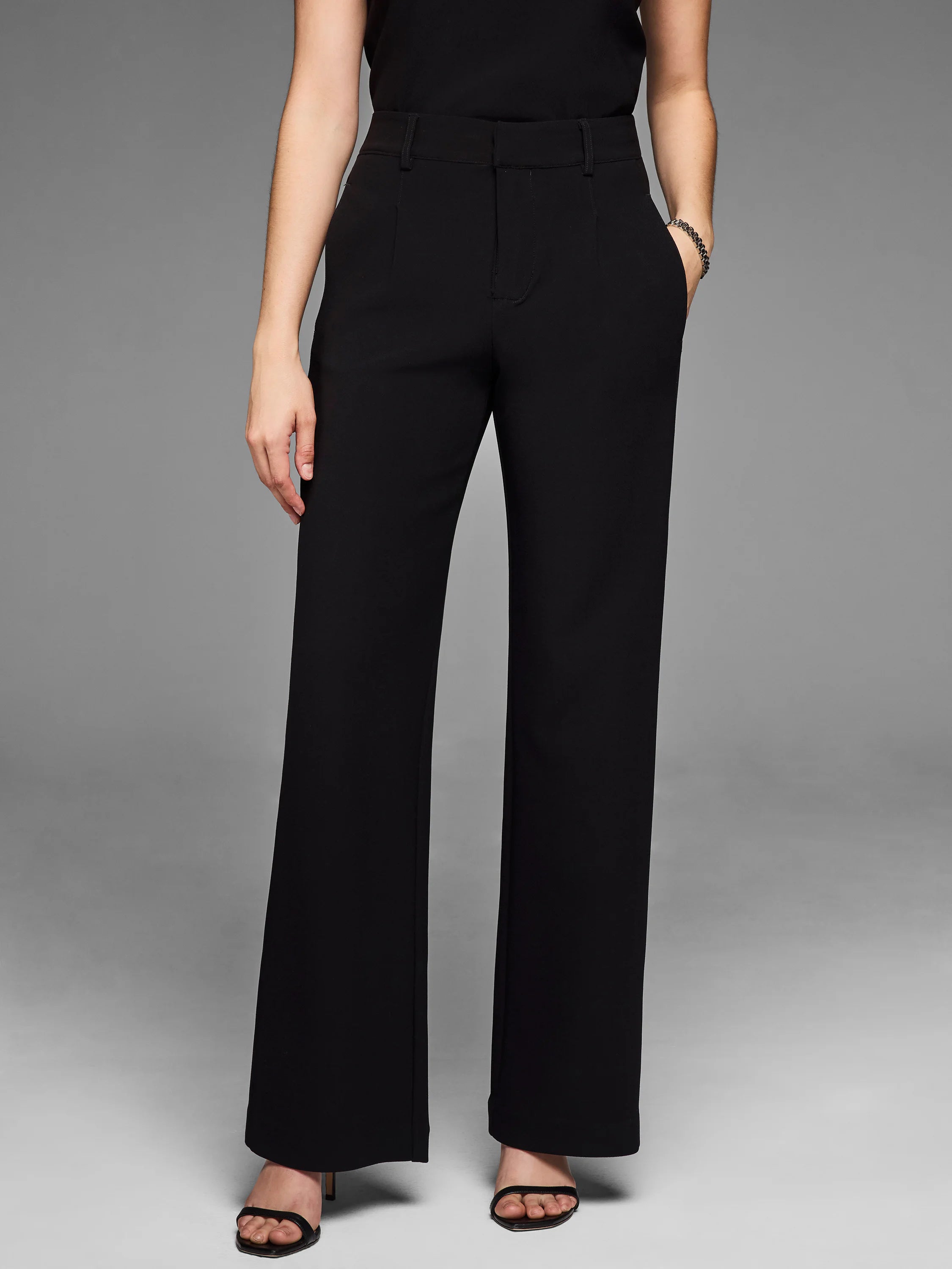 Black knit scuba wide-leg trousers. High-waisted with belt loops and front pockets.
